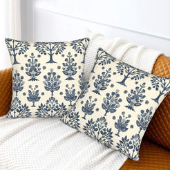 Block-print-inspired velvet pillow covers with navy folk floral trees, styled on a sofa