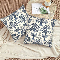 Block-print-inspired velvet pillow covers with navy tree-of-life gardens, styled on a woven chair