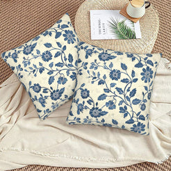 Block-print-inspired velvet pillow covers with navy small floral vines, styled on a woven chair