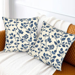 Block-print-inspired velvet pillow covers with navy rose vines, styled on a sofa