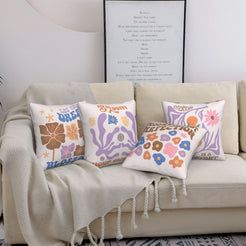Short-pile plush pillow covers with pastel retro flowers and motivational quotes, styled on a sofa