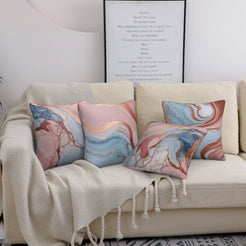 Four short-pile plush pillow covers with blush, blue and rose gold marble designs, styled on a sofa