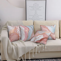 Four short-pile plush pillow covers with blush, blue and rose marble designs, styled on a sofa