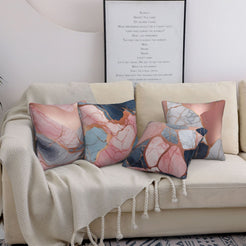 Four short-pile plush pillow covers with navy, blush and gray marble designs, styled on a sofa