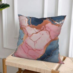 Short-pile plush pillow cover with navy, blush and gray marble designs, styled on a woven chair