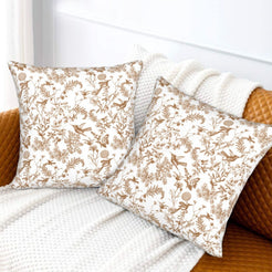 Toile floral velvet pillow covers with tan birds and wildflowers on white, styled on a sofa
