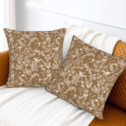 Toile floral velvet pillow covers with white birds and wildflowers on tan, styled on a sofa