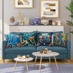 Coastal short-pile plush pillow covers with dolphins, koi fish, jellyfish and seahorses, styled on a blue sofa