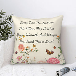 Velvet pillow cover with cream floral pattern and heartfelt love quote, styled by a window