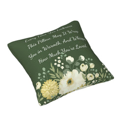 Angled view of a velvet pillow cover with dark green floral pattern and heartfelt love quote