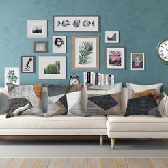 Short-pile plush pillow covers with gray, brown and black abstract geometry, styled on a cream sectional