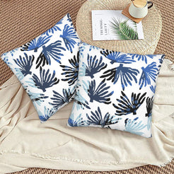 Coastal velvet pillow covers with navy coral fronds on white, styled on a floor cushion