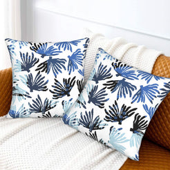 Coastal velvet pillow covers with navy coral fronds on white, styled on a bed