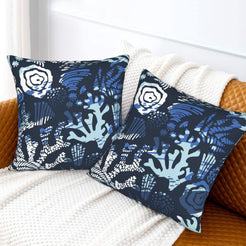 Coastal velvet pillow covers with midnight blue coral and flowers, styled on a bed