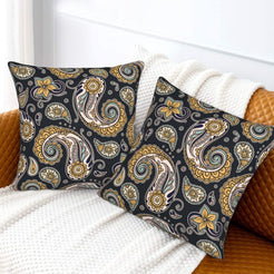 Velvet pillow covers with black and ochre paisley, styled on a white sofa