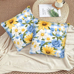 Velvet pillow covers with sunflowers, blue roses and blue gingham, styled on a floor cushion
