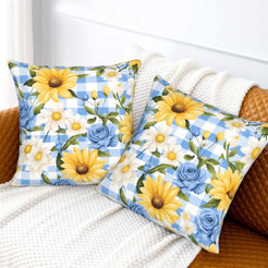 Velvet pillow covers with sunflowers, blue roses and blue gingham, styled on a bed