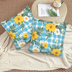 Velvet pillow covers with yellow daisies and aqua gingham, styled on a floor cushion