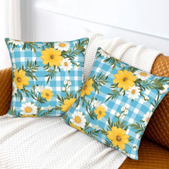 Velvet pillow covers with yellow daisies and aqua gingham, styled on a bed