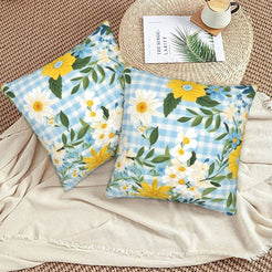 Velvet pillow covers with blue and yellow wildflowers with pale gingham, styled on a floor cushion