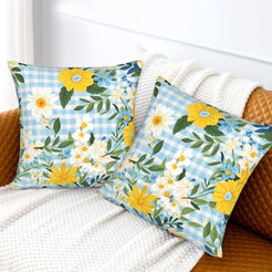 Velvet pillow covers with blue and yellow wildflowers with pale gingham, styled on a bed