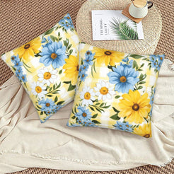 Velvet pillow covers with sunflowers and blue daisies on yellow gingham, styled on a floor cushion