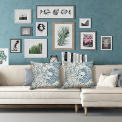Water-resistant linen-look polyester pillow covers with blue octopus, shells and sea plants, styled on a cream sofa