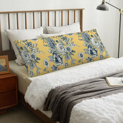 Large blue floral mustard body pillow cover styled across a bed