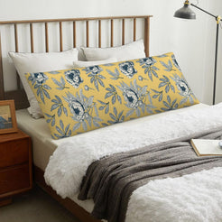 Scattered blue floral mustard body pillow cover styled across a bed