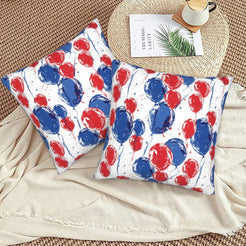 4th of July velvet pillow covers with red and blue balloons, styled on a woven chair