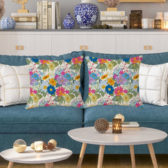 Water-resistant pillow covers with cream dense multicolor wildflowers, styled on a teal sofa