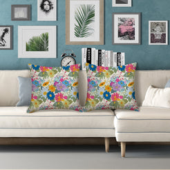 Water-resistant pillow covers with cream dense multicolor wildflowers, styled on a white sofa