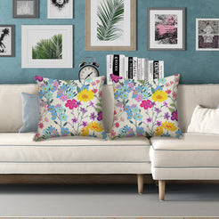 Water-resistant pillow covers with cream pastel wildflower bouquets, styled on a white sofa