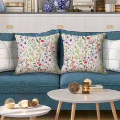 Water-resistant pillow covers with cream delicate wildflower stems, styled on a teal sofa