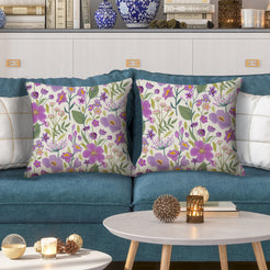 Water-resistant pillow covers with cream purple wildflowers, styled on a teal sofa