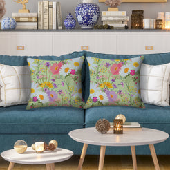 Water-resistant pillow covers with sage multicolor wildflowers, styled on a teal sofa