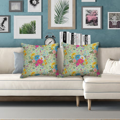Water-resistant pillow covers with sage pink and blue wildflowers, styled on a white sofa