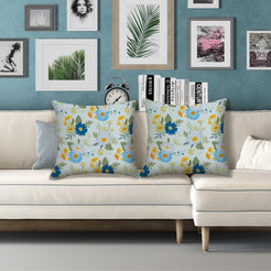 Water-resistant pillow covers with pale blue yellow and blue flowers, styled on a white sofa