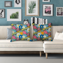 Water-resistant pillow covers with dark green multicolor meadow flowers, styled on a white sofa