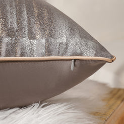 Side view of a taupe jacquard pillow cover with hidden zipper
