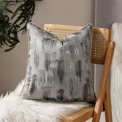 Silver gray abstract jacquard pillow covers styled on a chair