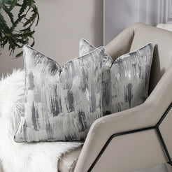 Silver gray abstract jacquard pillow covers styled on a sofa