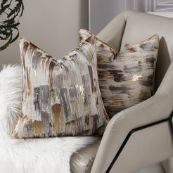 Brown and gold abstract jacquard pillow covers styled on a sofa