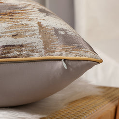 Side view of a brown and gold jacquard pillow cover with hidden zipper