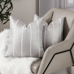 Silver vertical stripe jacquard pillow covers styled on an armchair
