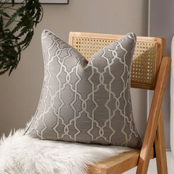 Gray trellis jacquard pillow covers styled on a chair