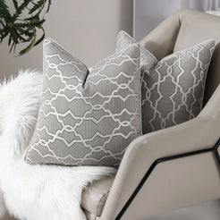 Gray trellis jacquard pillow covers styled on an armchair