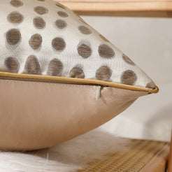 Close-up of cream and gold dot jacquard fabric with hidden zipper