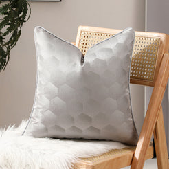 Silver honeycomb jacquard pillow covers styled on a chair