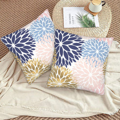Charcoal, blush and gold dahlia pattern velvet pillow covers styled on a woven chair